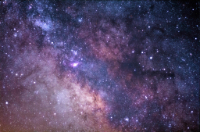 Photograph of space with stars and stardust.